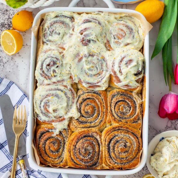 a large casserole pan filled with lemon poppy seed rolls, on a table