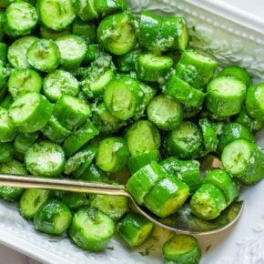 A closeup image of cucumber salad in a bowl.