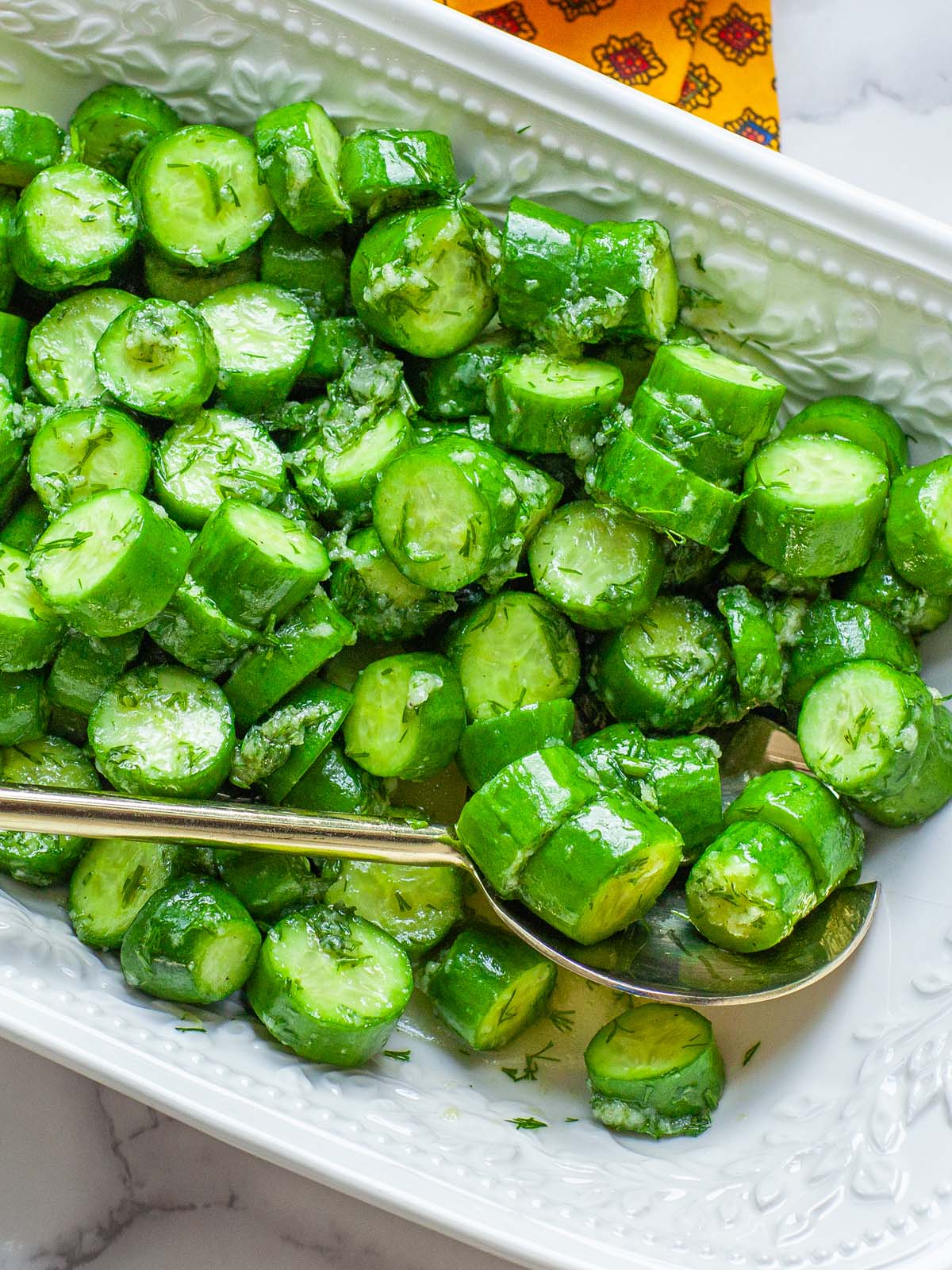 A closeup image of cucumber salad in a bowl.